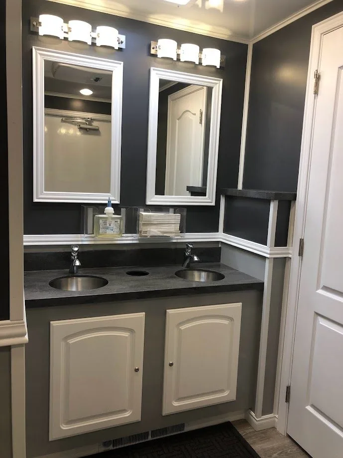 Multi-station restroom trailer interior with a full row of sinks, sized for school campuses and student populations