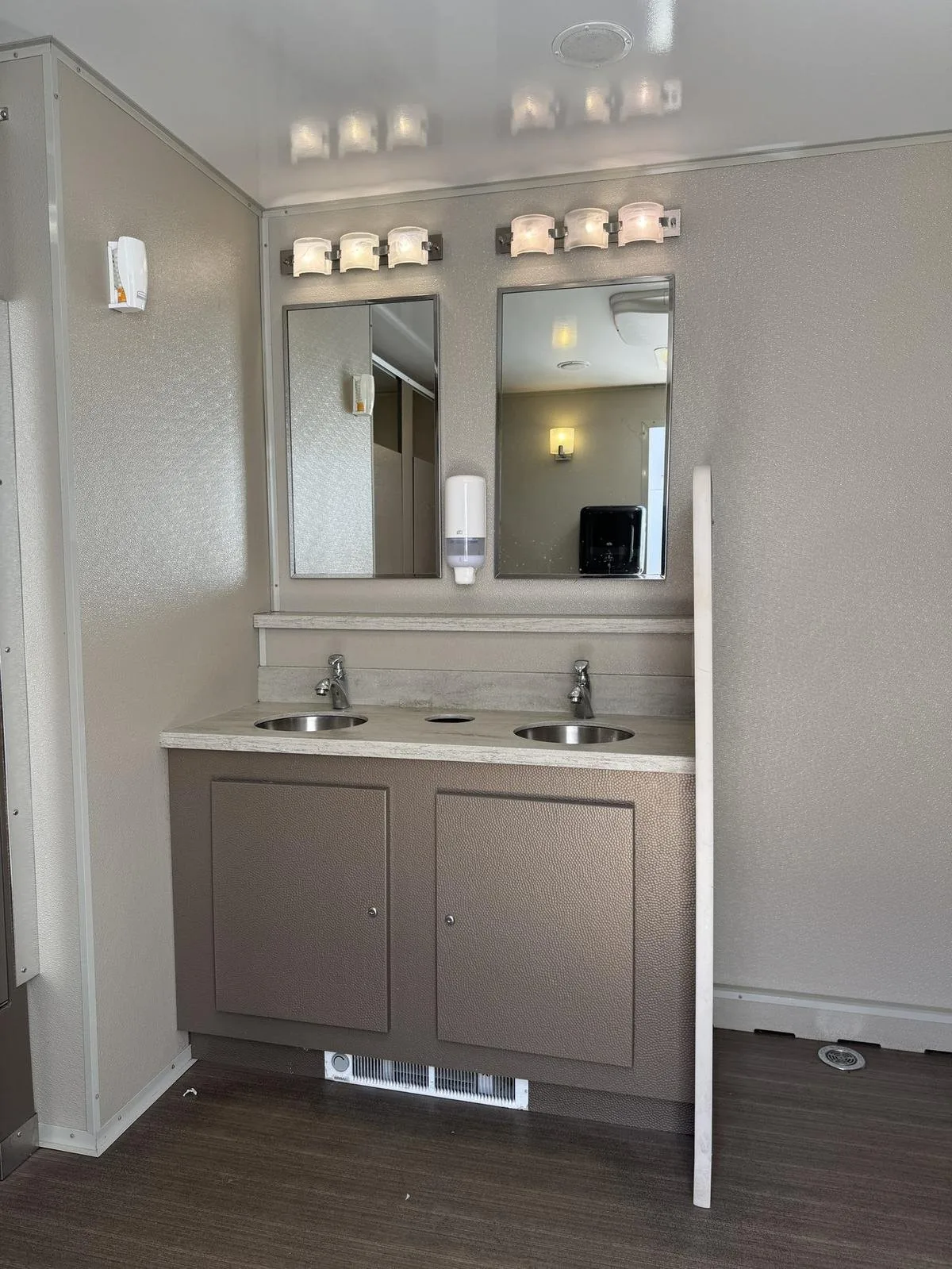 Double-sink vanity interior of a restroom trailer suitable for office staff during a renovation