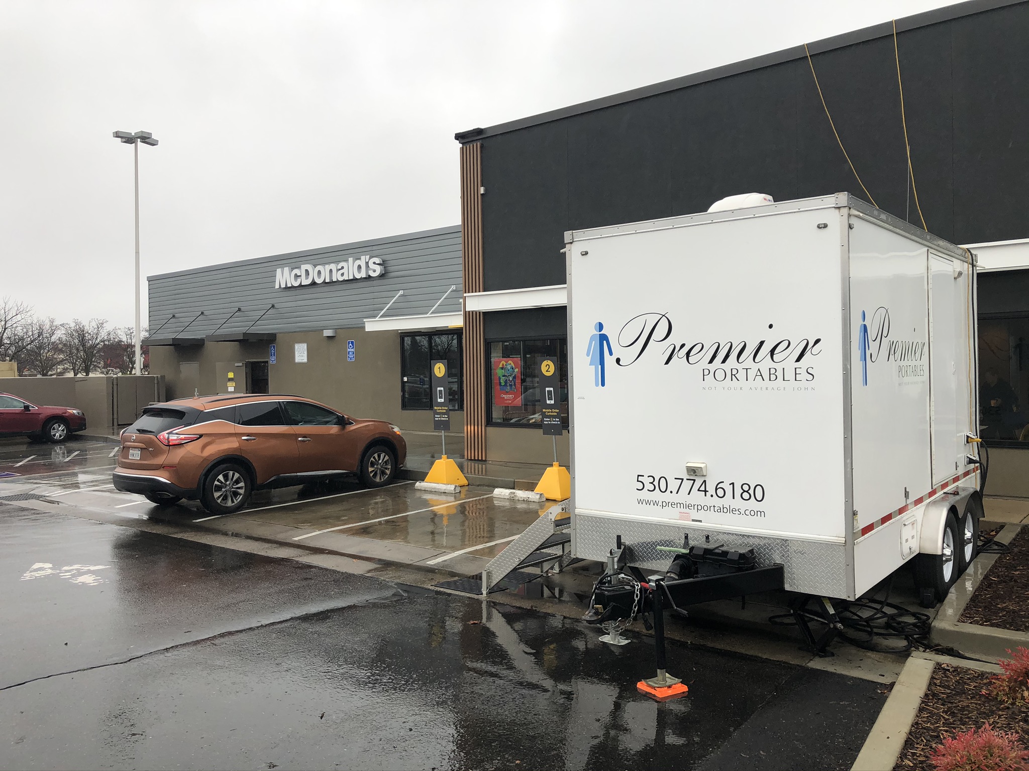 NorCal Restroom Trailers luxury restroom trailer on site at a McDonald's in Northern California, branding and phone number visible