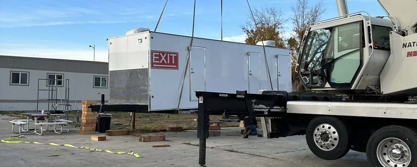 National Crane hoisting a restroom trailer into position at the Fleet Development Program site, Sacramento region