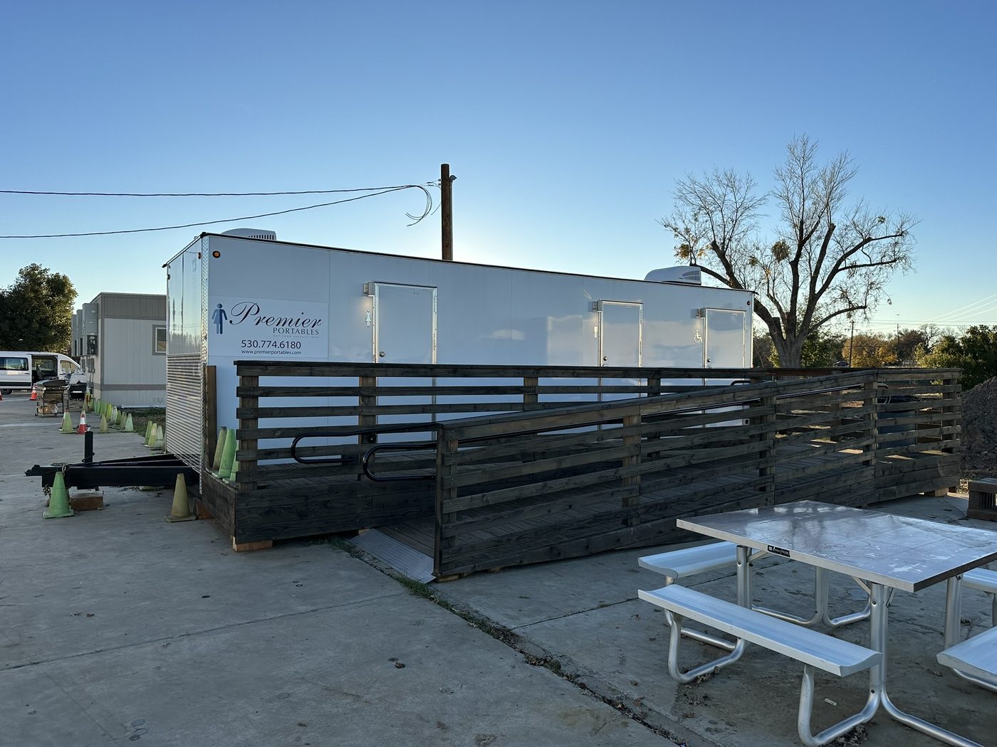 Fully installed restroom trailer with custom wood ADA ramp at the Fleet Development Program site, Sacramento region
