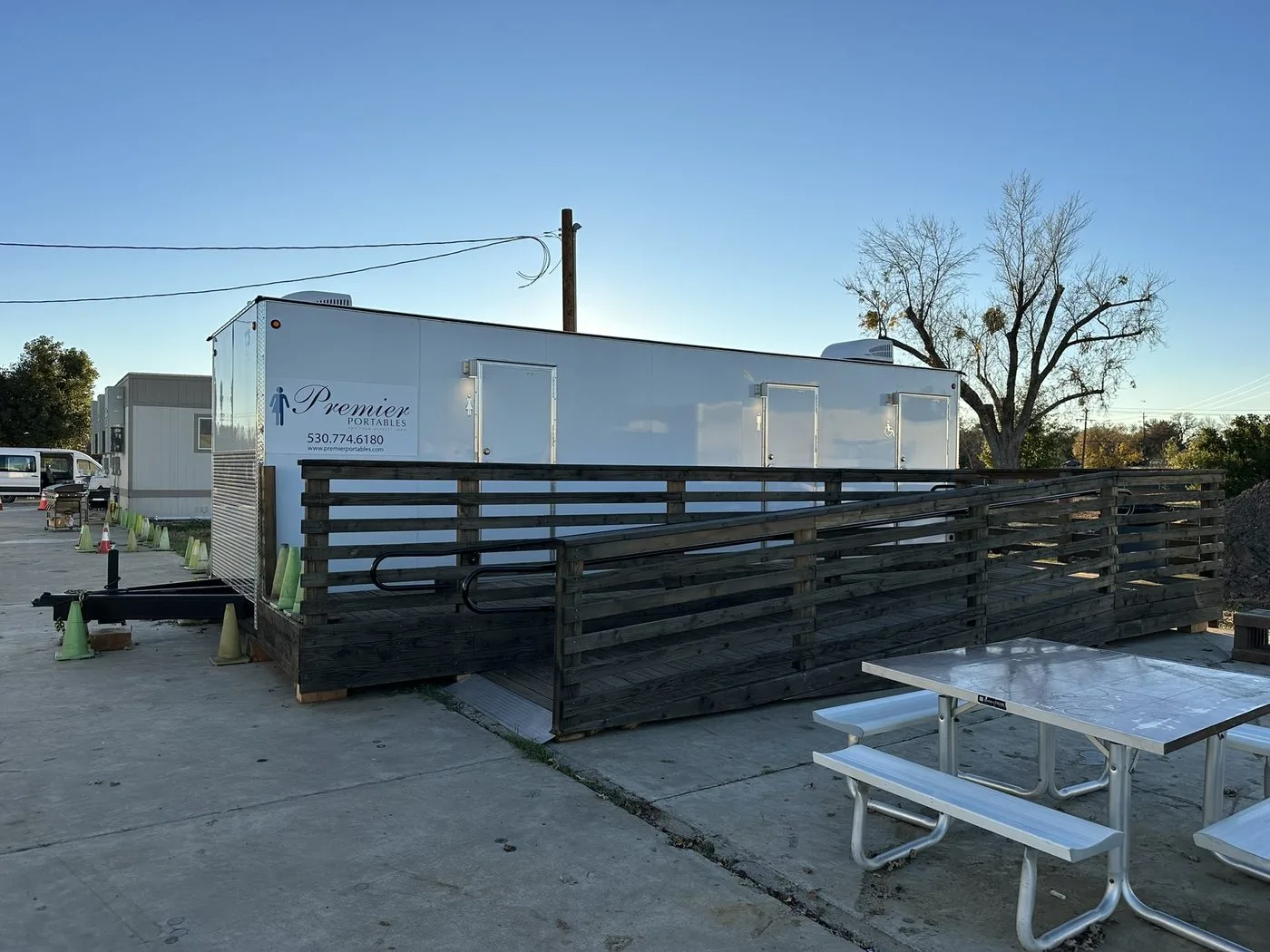 Fully installed restroom trailer with custom wood ADA ramp at the Fleet Development Program site, Sacramento region